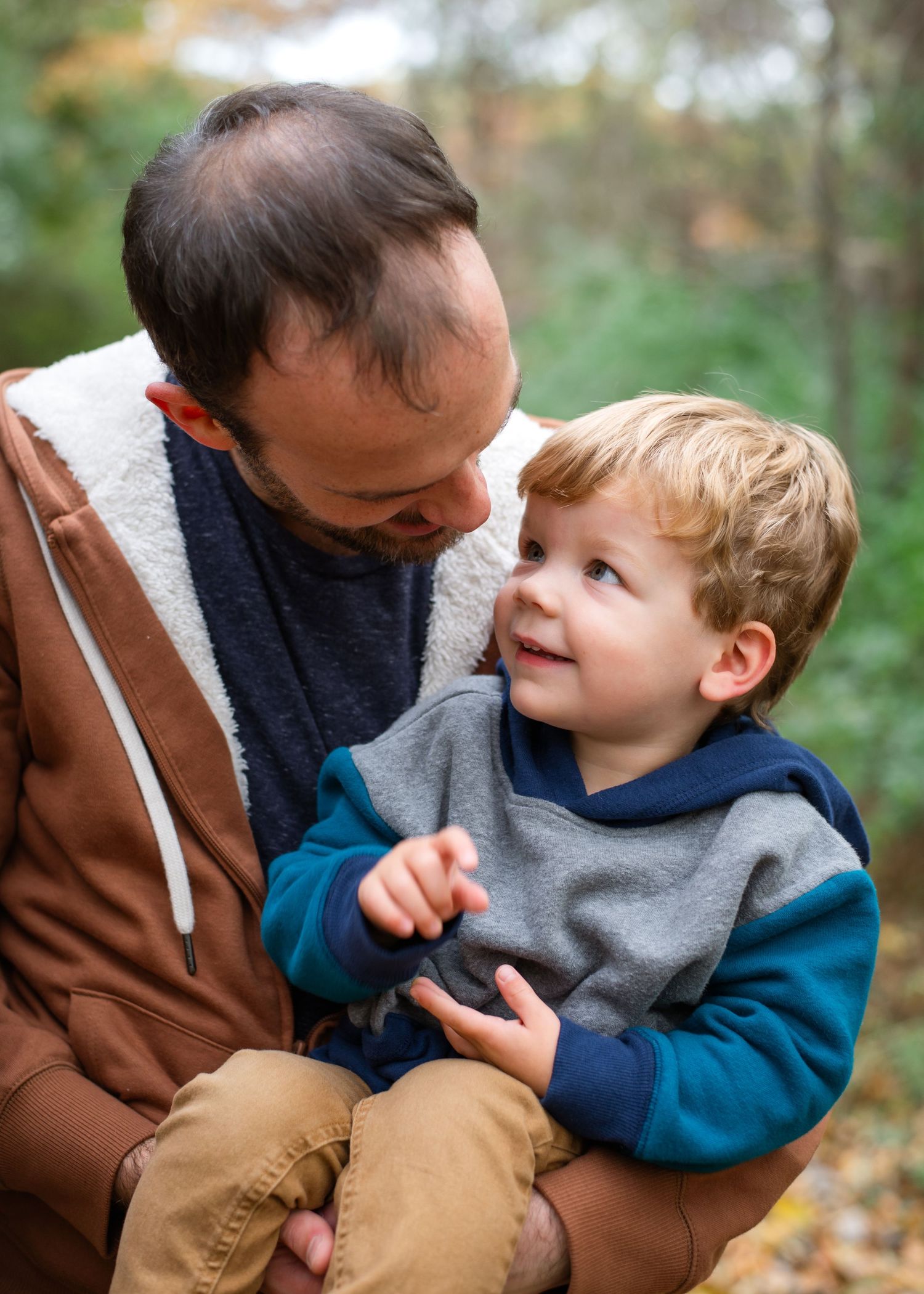 Three candid lifestyle portraits show a young boy in a brown sweater playing with someone outdoors.