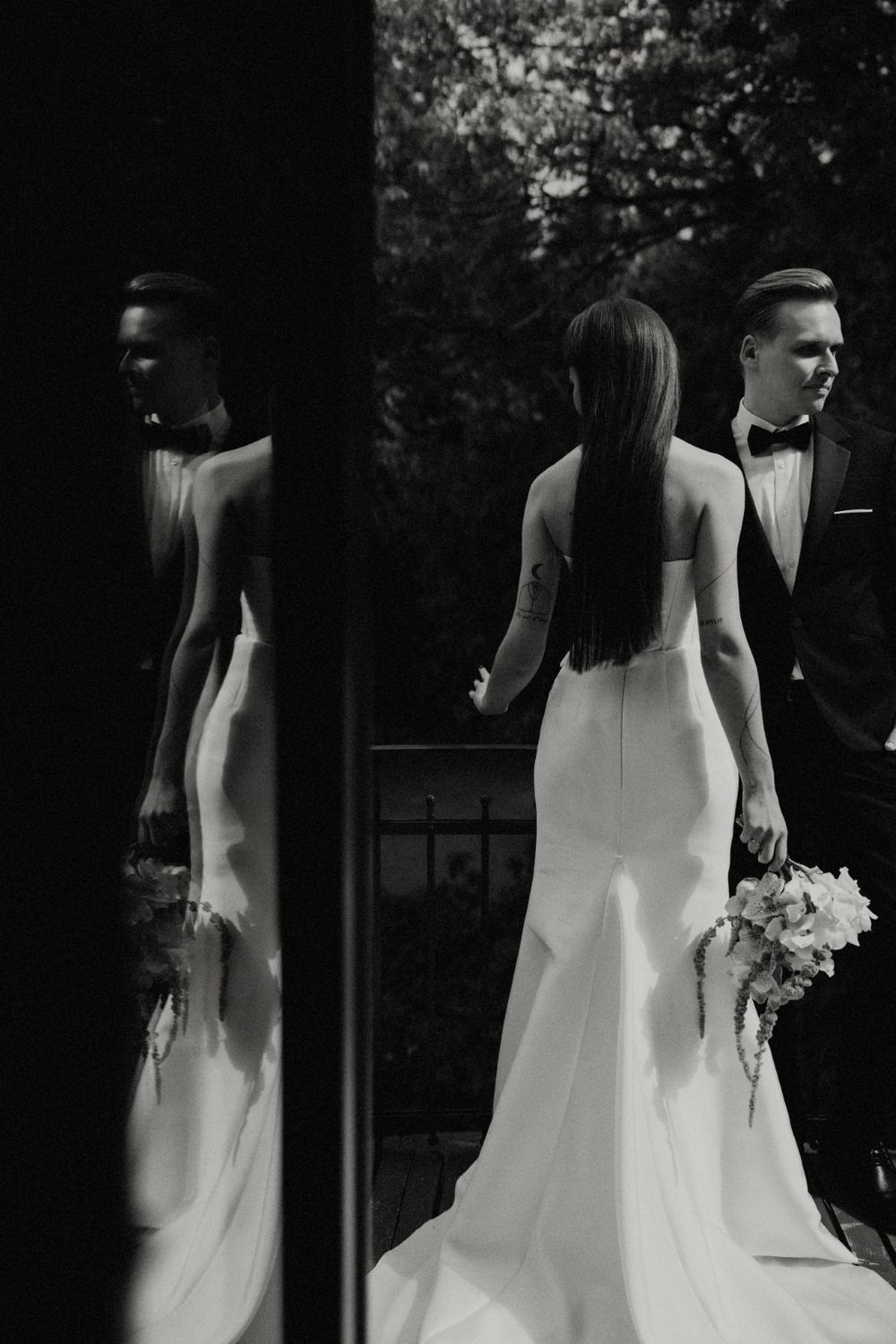 Black and white wedding portrait series with dramatic shadows and elegant composition.