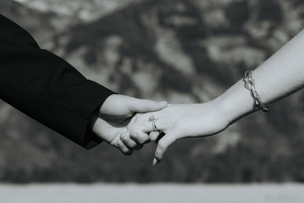 Artistic black and white photo sequence of two hands coming together, showing a progression of the moment of touch.
