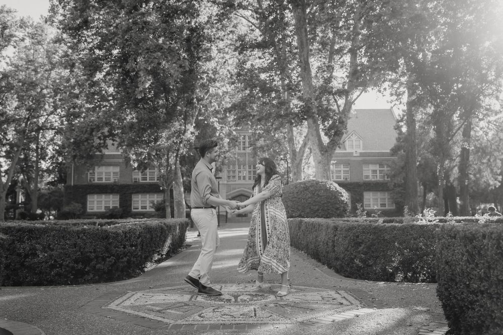 A historic black and white photograph of a roundabout intersection, lined with trees and buildings in an urban setting.