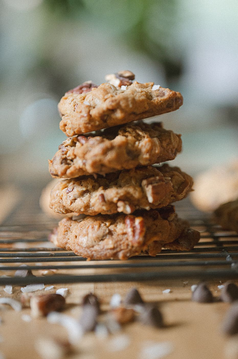 Close-up view of stacked homemade chocolate pecan cookies on a wire cooling rack.