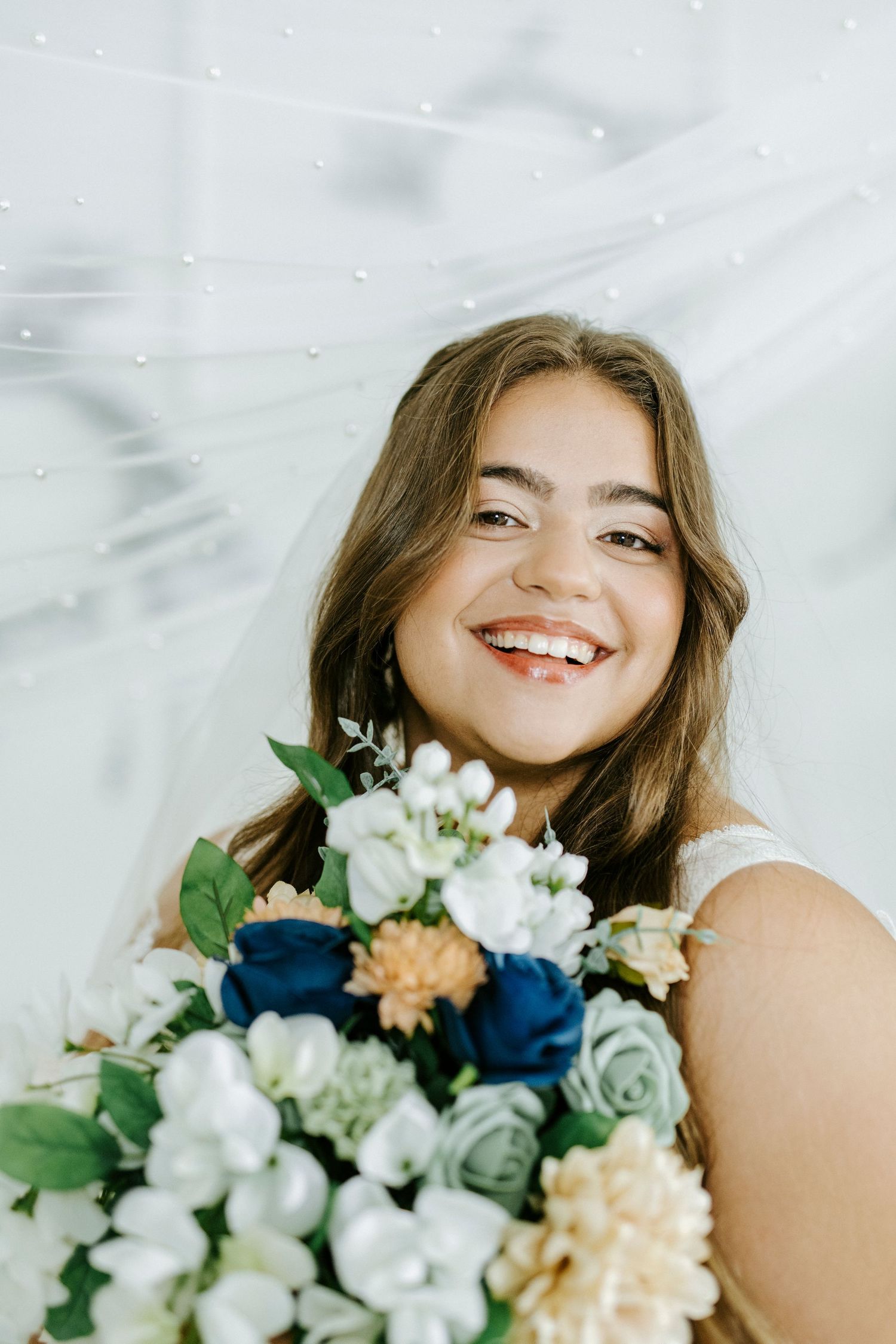 Close-up portrait series with white and peach floral bouquet against light background.
