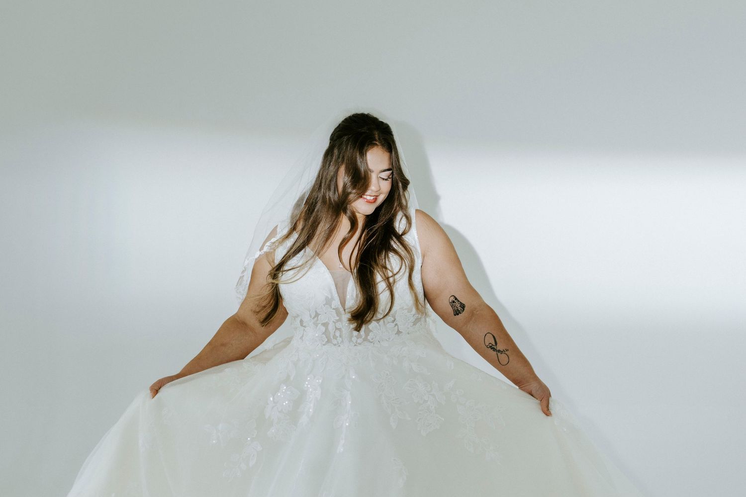 A wedding dress with delicate lace overlay and fitted silhouette flows gracefully across multiple photos.