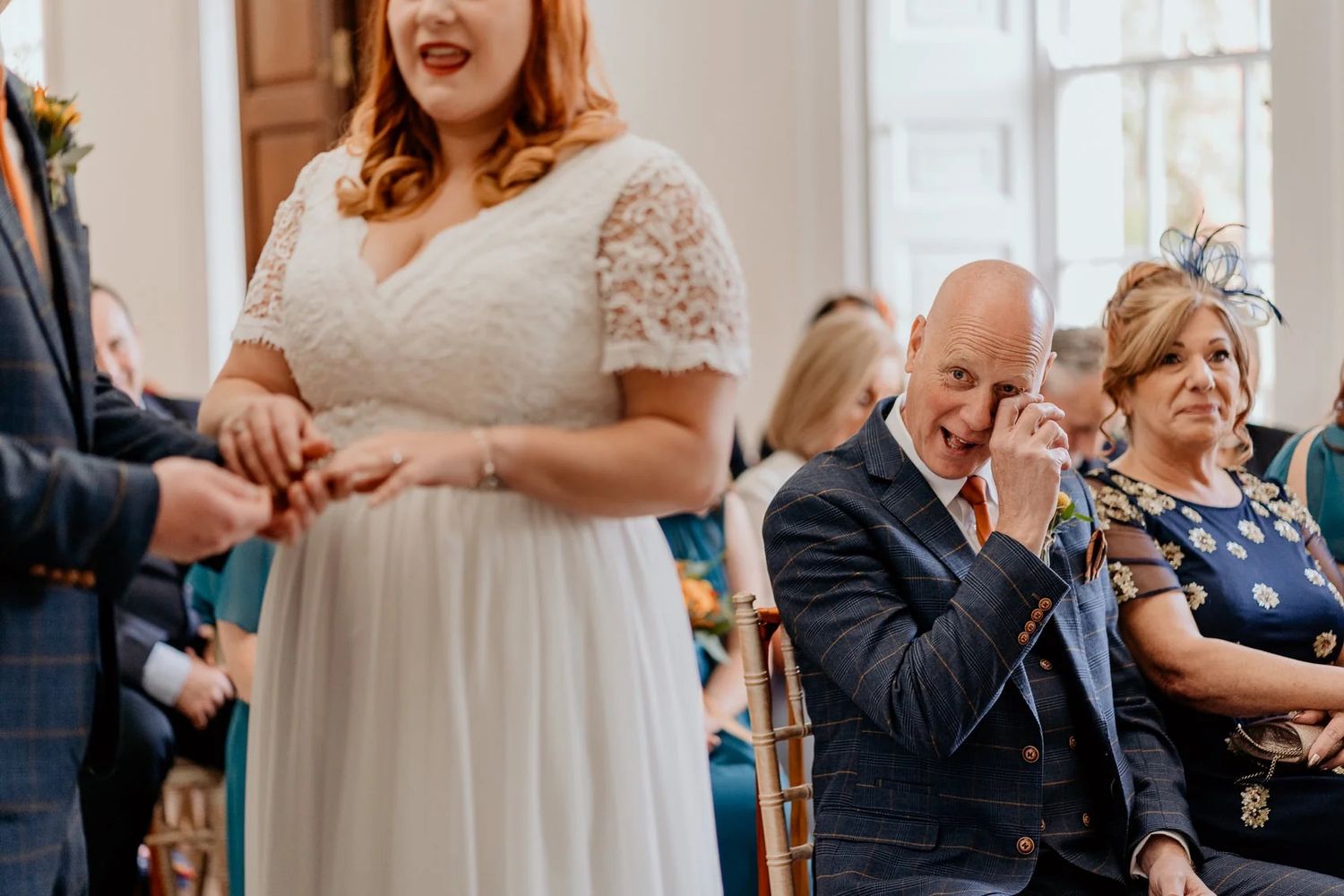 Wedding celebration in a bright room with white decor and joyful moments.