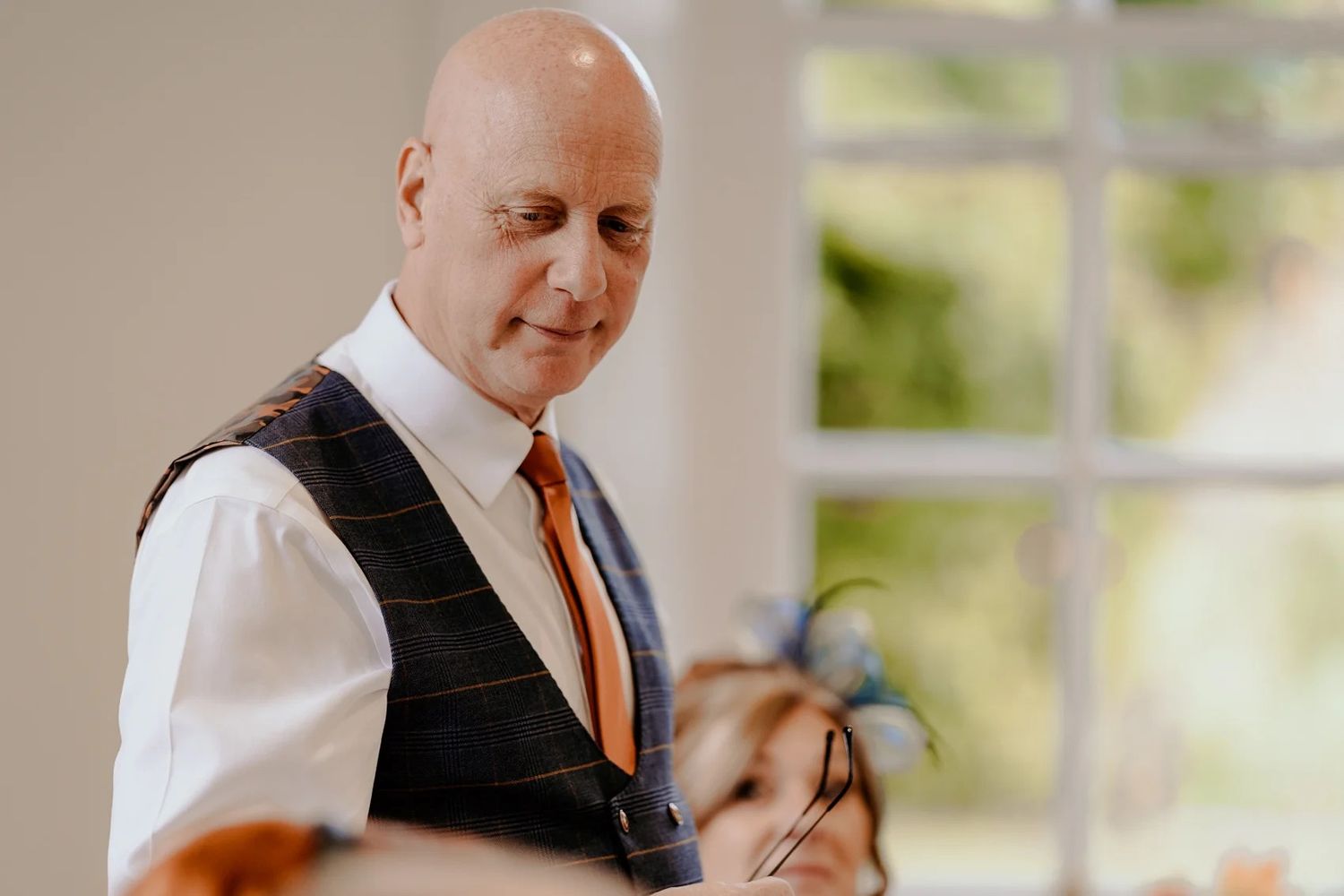 Professional working in an office space setting wearing a white shirt and tie.