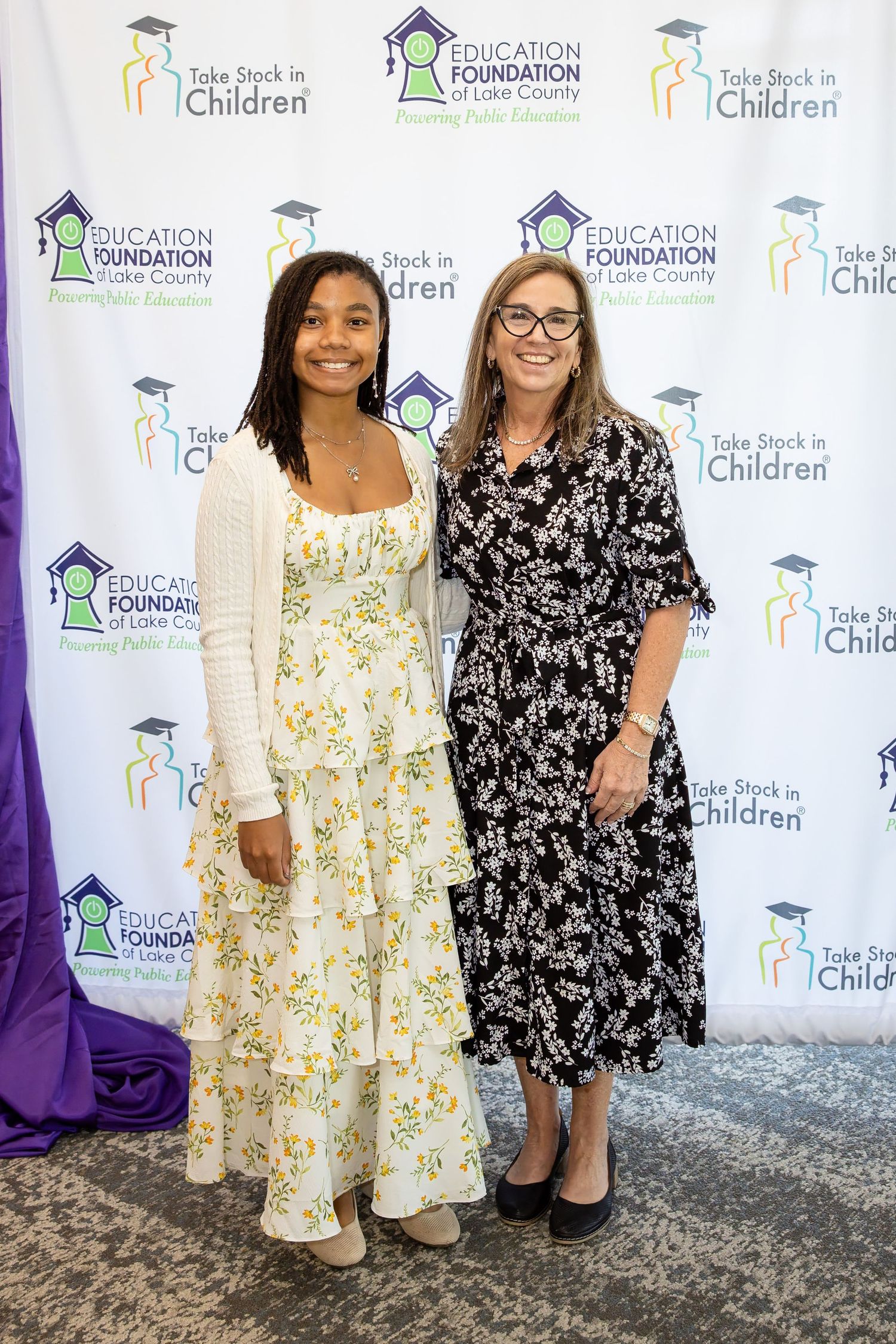 Two women pose together at an Education Foundation of Lake County and Take Stock in Children event.