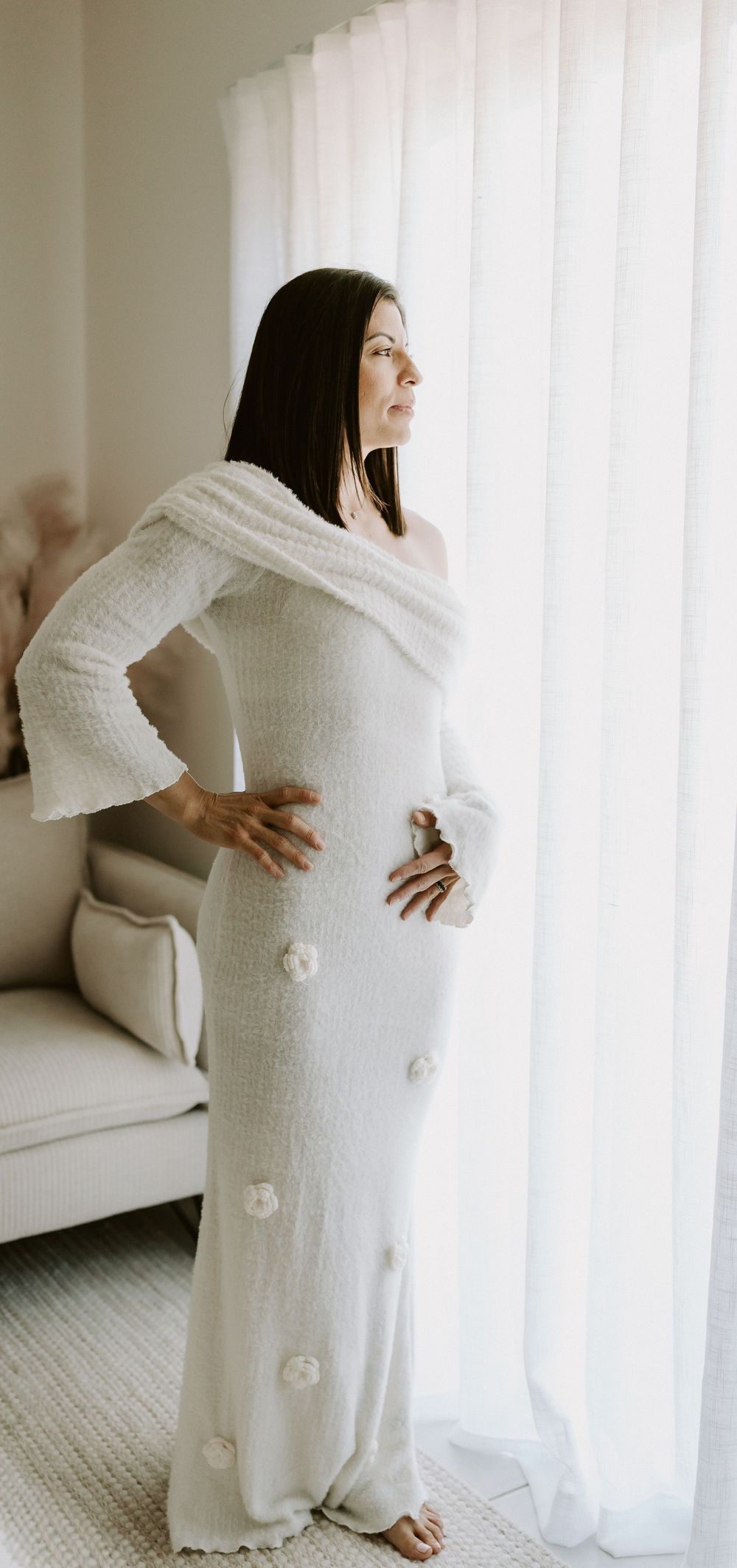 A woman wearing a dress from Captured by Janette's Client wardrobe, posing in her Glenview home studio on the Sunshine Coast.