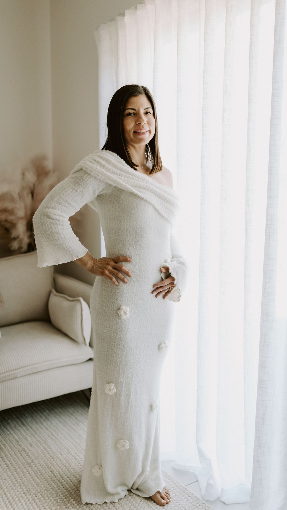A woman wearing a dress from Captured by Janette's Client wardrobe, posing in her Glenview home studio on the Sunshine Coast.