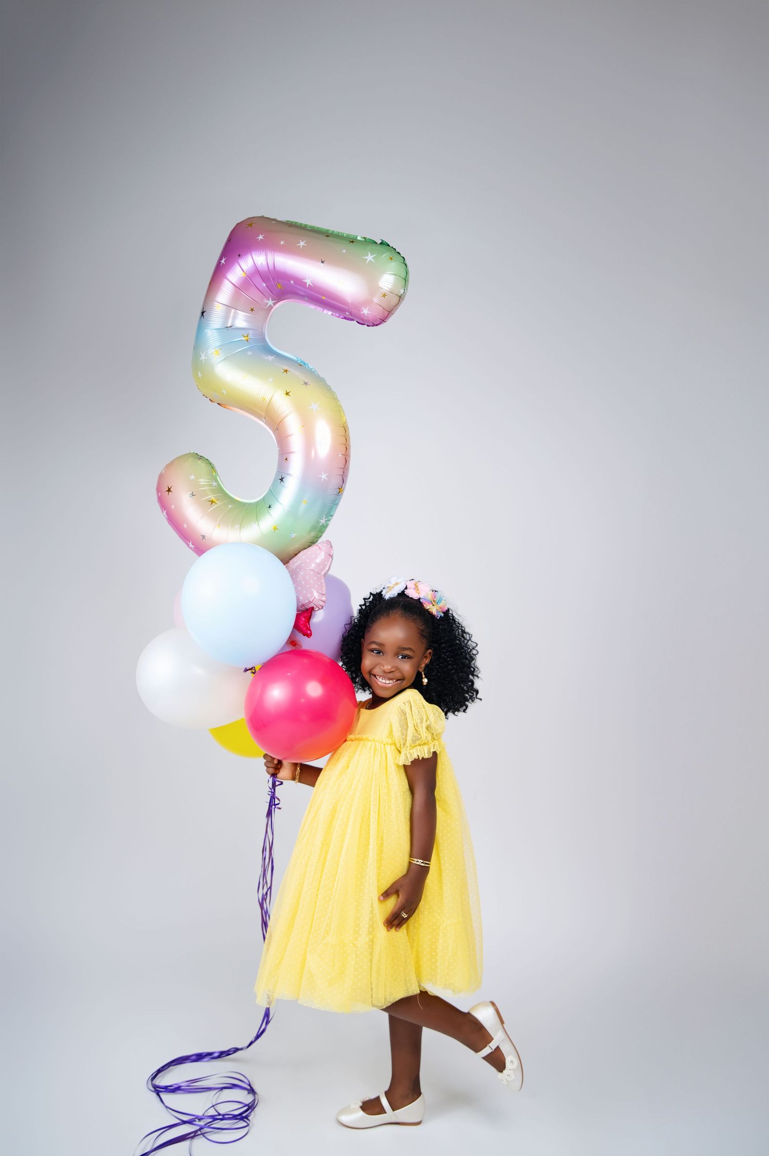 Dynamic fashion shoot featuring flowing red ruffled dress against grey background.