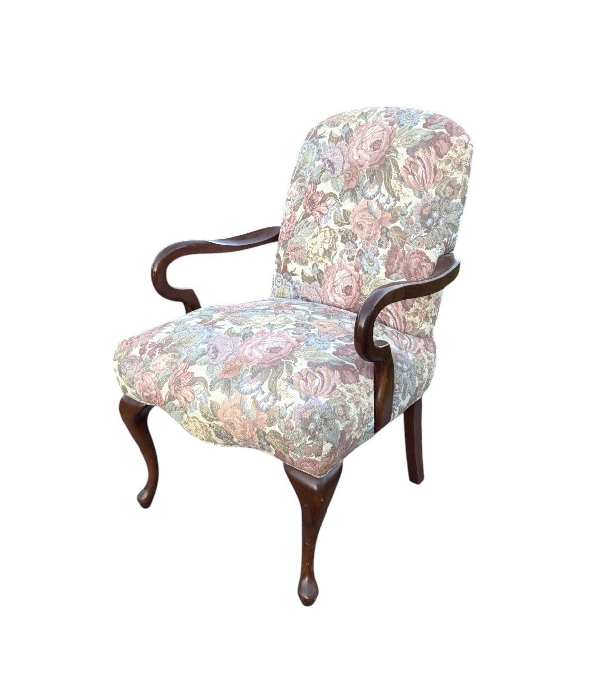 A vintage French-style settee with light gray upholstery and wooden frame sits elegantly on grass with trees in background.