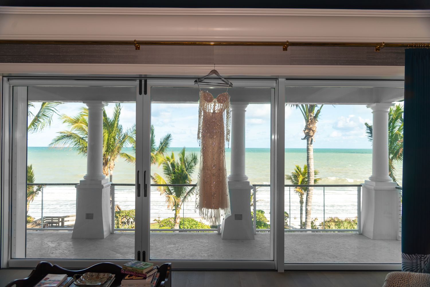 The hanging bride's dress, backdropped by the ocean, from the terrace of the estate.