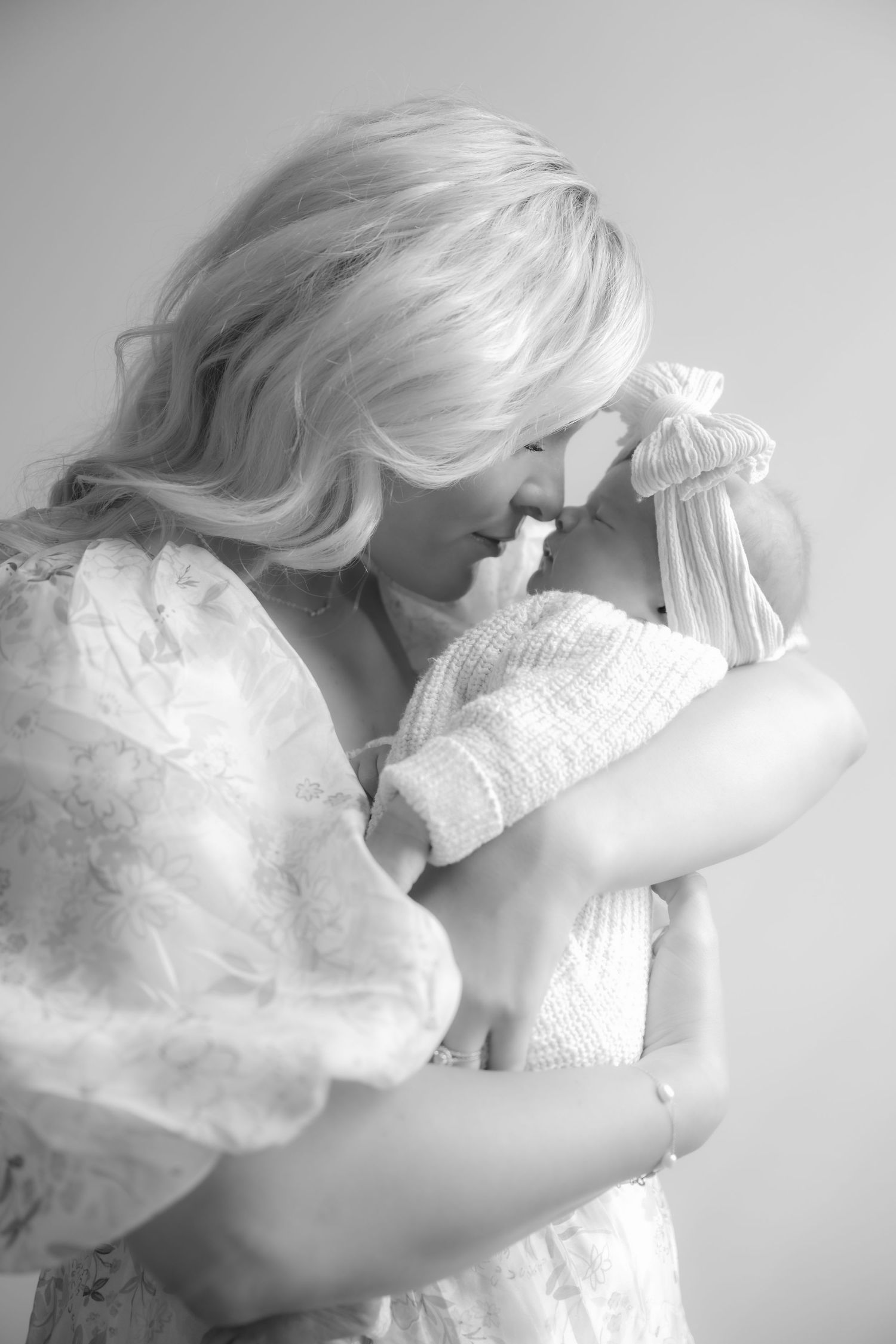 black and white of mom nose to nose with her newborn baby during in studio lifestyle newborn session in stillwater, mn