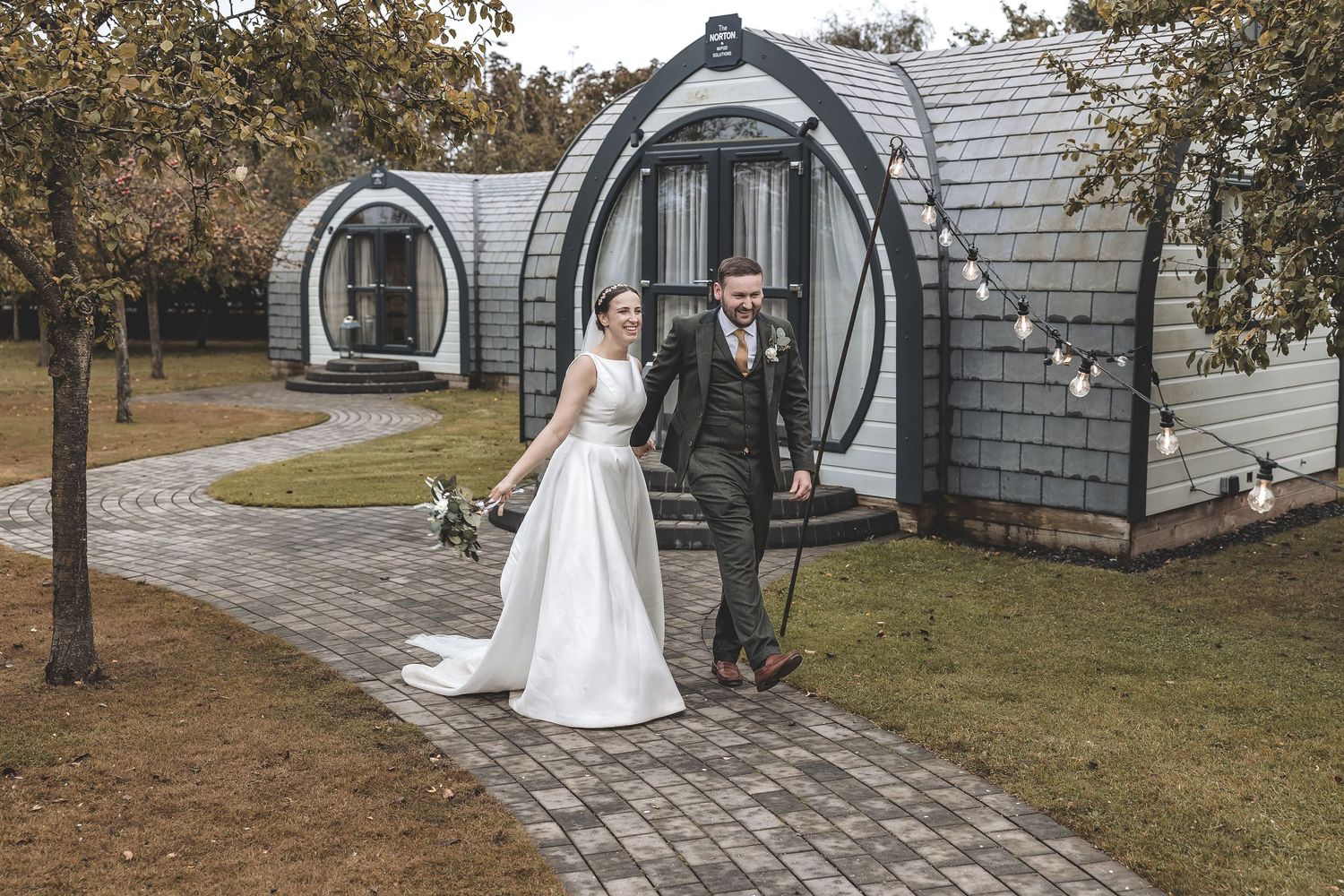 Wedding couple interacting during a relaxed walk within the venue grounds