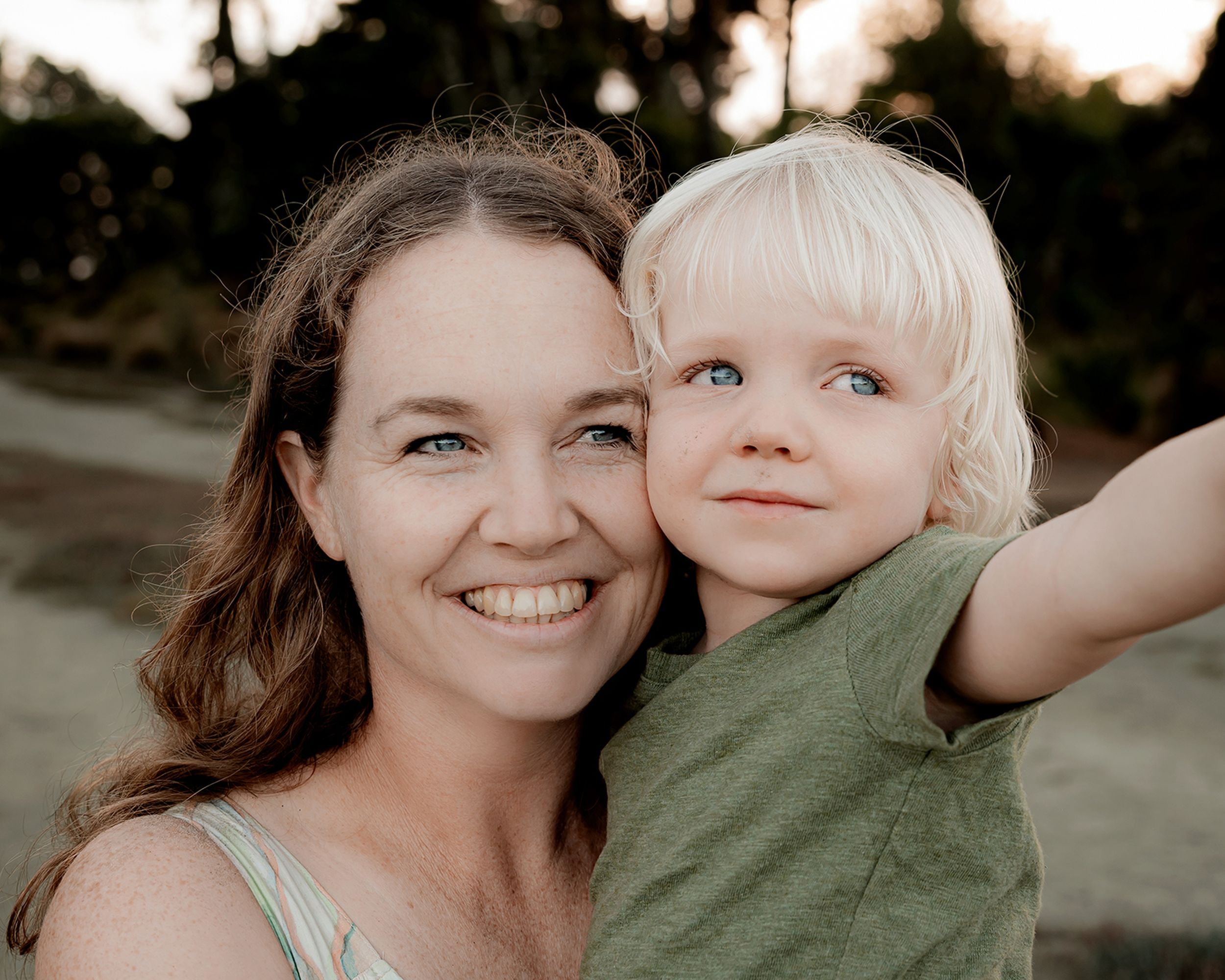 Mother cuddling her young child during portrait session