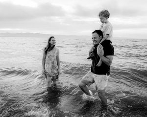 Mother and father laughing with their children