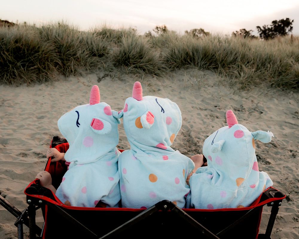 Young family enjoying time together after their family session at the beach