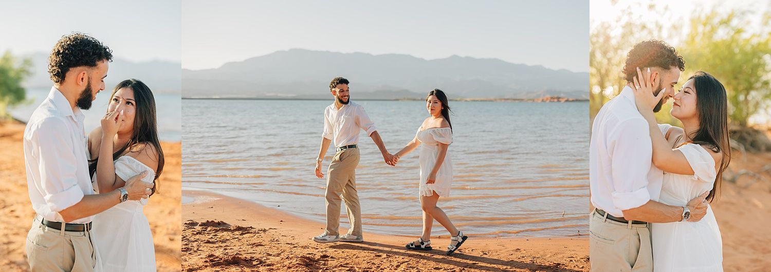 Couple holds hands and poses on sandy lakeside beach during golden hour engagement photo session.