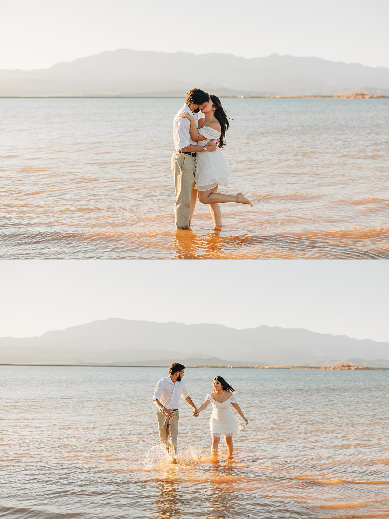Couple kissing and splashing in shallow lake water with mountain backdrop during golden hour engagement shoot.