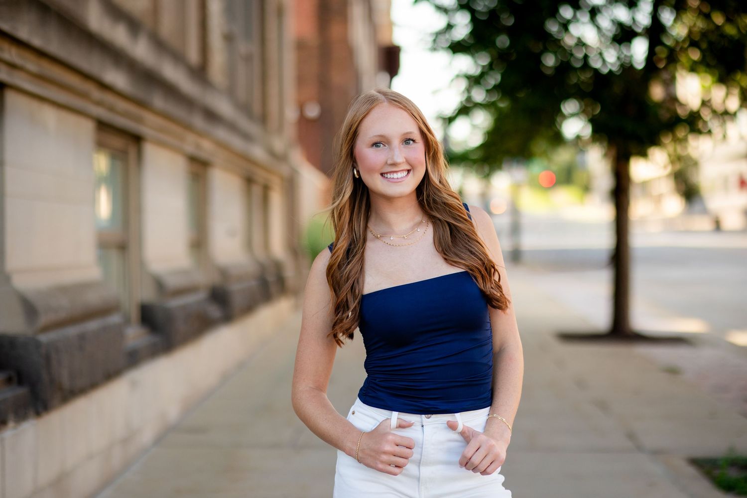 Senior girl in downtown Cedar Rapids wearing a casual outfit with her Marion senior photographer.