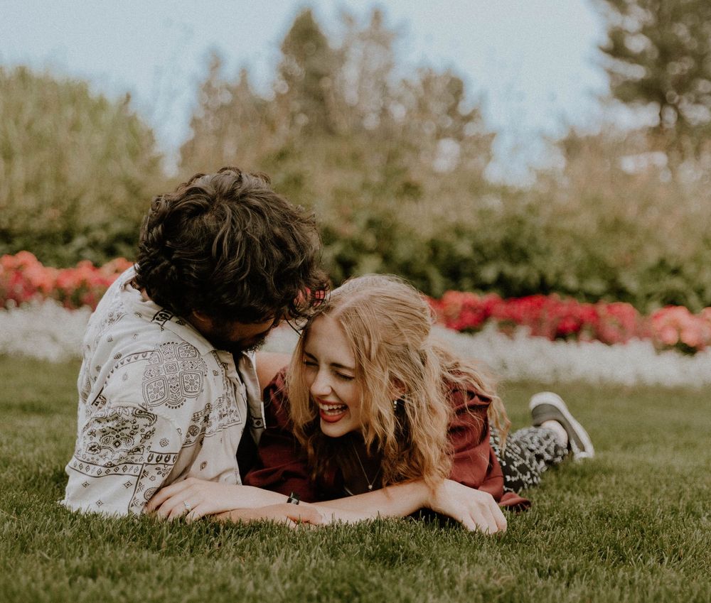 Couple laughs with each other for candid couples, engagement photos, elopement, and cinematic photos in Denver, Colorado