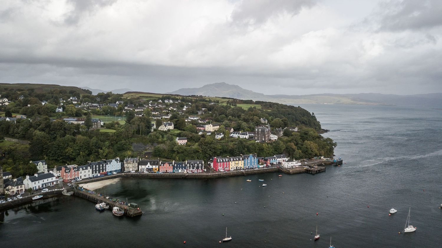 Aerial view of colorful waterfront buildings and harbor of Tobermory on the Isle of Mull, Scotland.