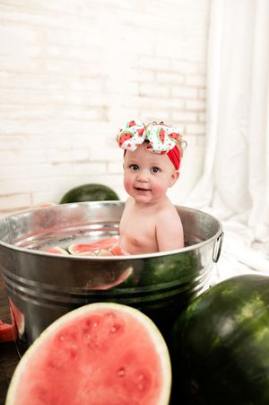 Watermelon-themed photo series featuring a bathtub scene with fresh watermelon slices and pink decor.