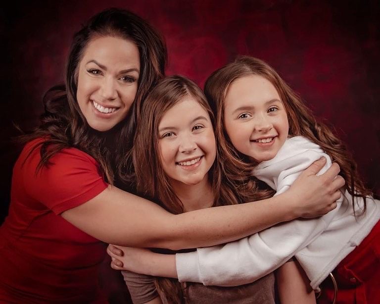 Family portrait series showing loving embraces against deep burgundy backdrop.