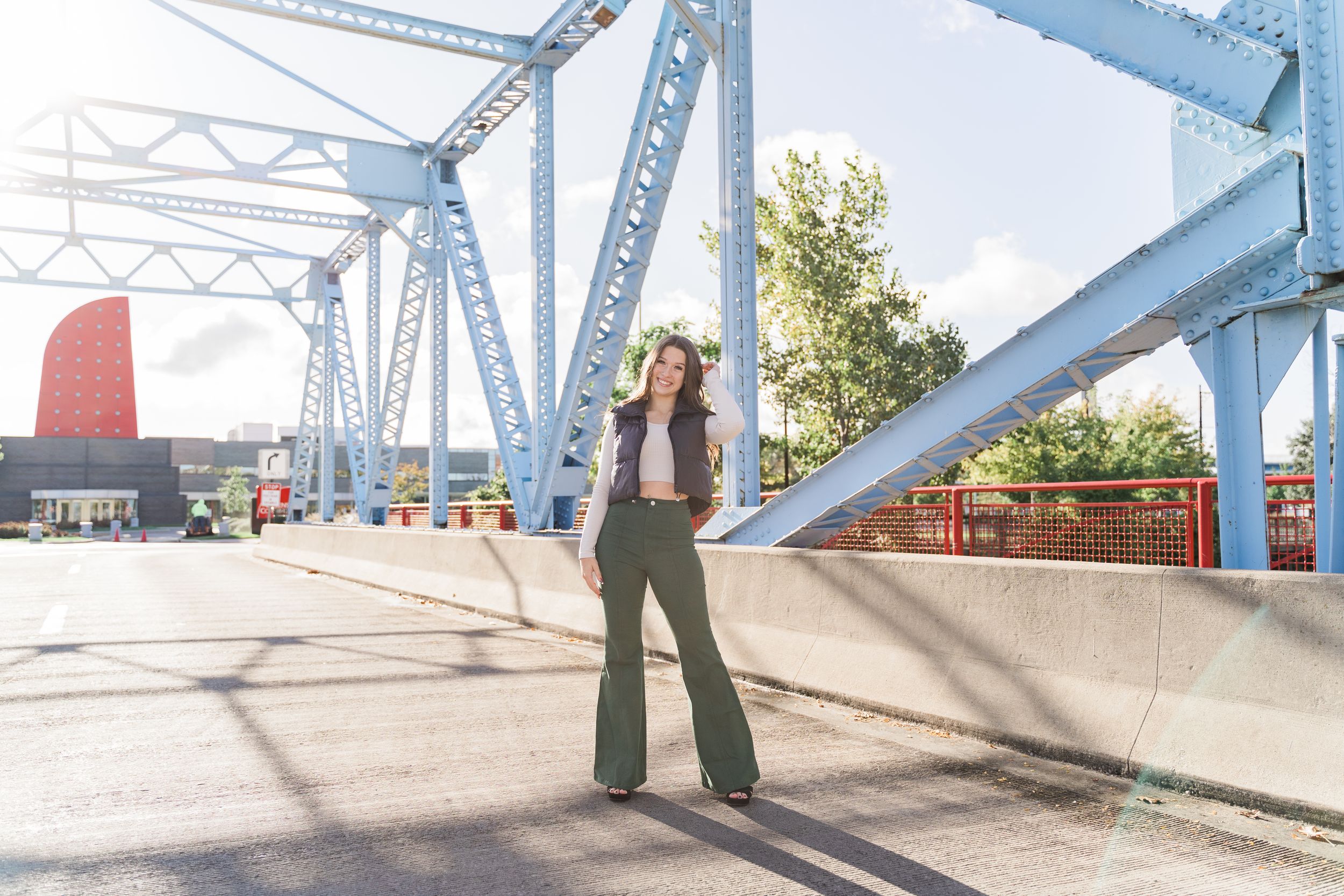 A series of connected photos showing people walking across a white painted bridge or walkway structure.