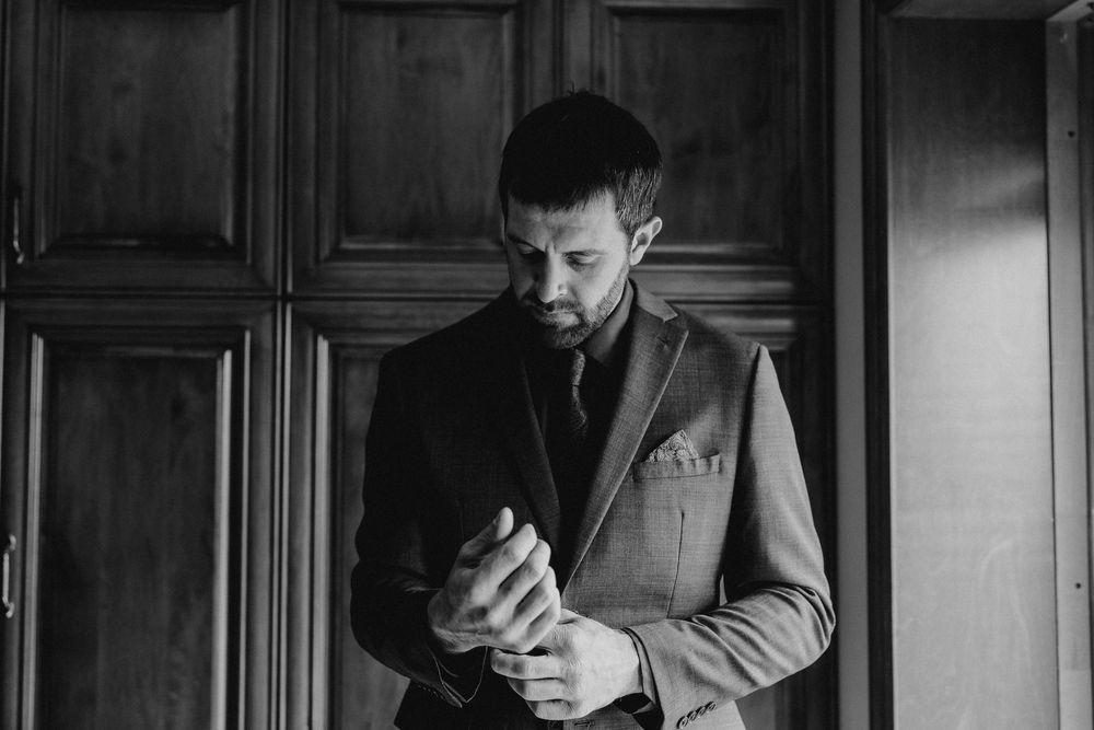 groom fastening his cufflink