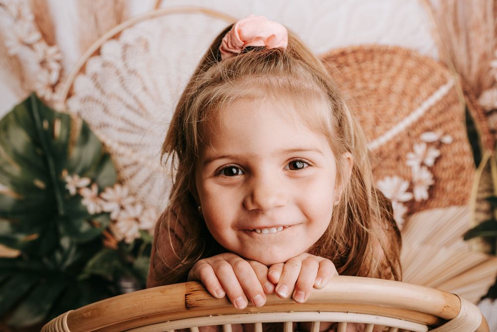 Vintage inspired photography scene with wicker furniture and soft lighting.