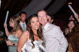 People dancing and celebrating together at a lively wedding reception party on the dance floor.