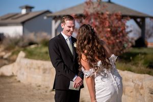 A couple shares a romantic moment during their autumn wedding photoshoot outdoors.