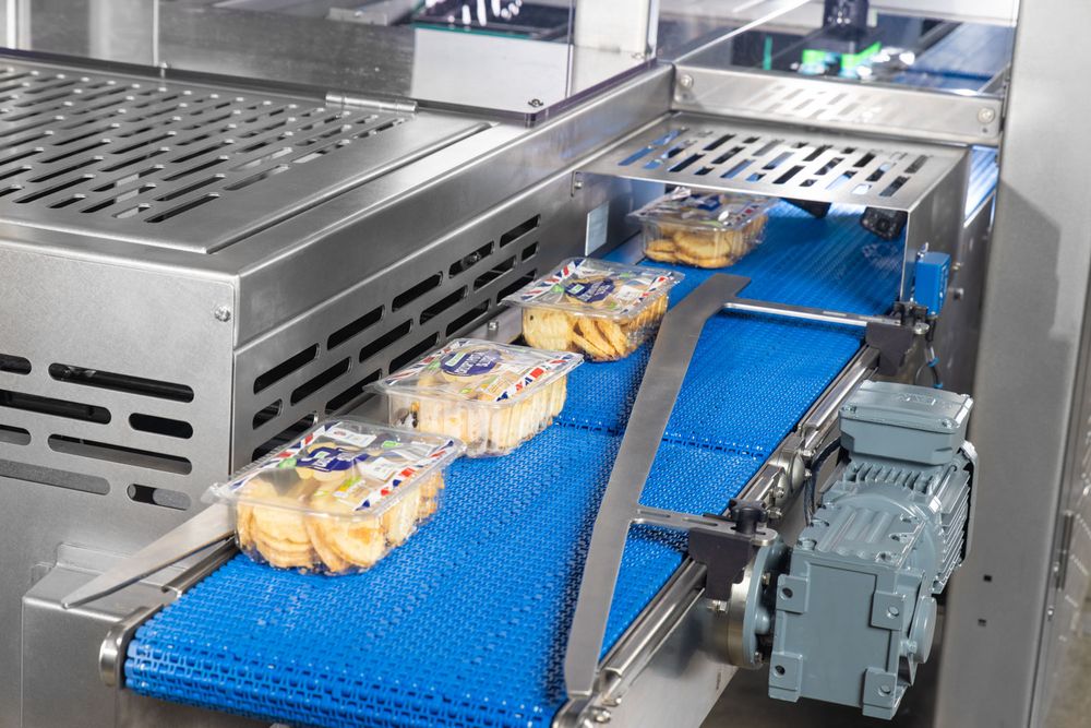 Brilopak packing machines and robotic arms on a modern factory floor-02