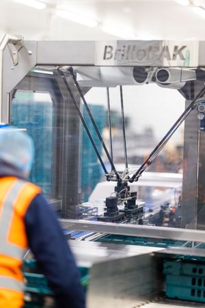 Brilopak packing machines and robotic arms on a modern factory floor-07