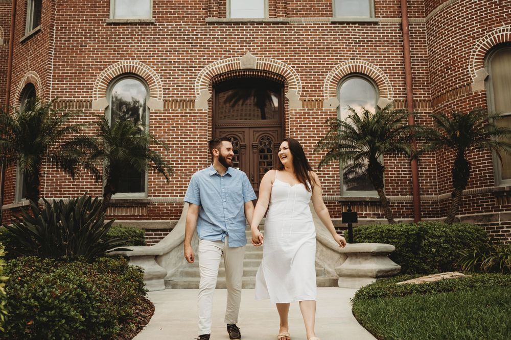 Couple laughing together during a romantic engagement session at The Henry B. Plant Museum in Tampa