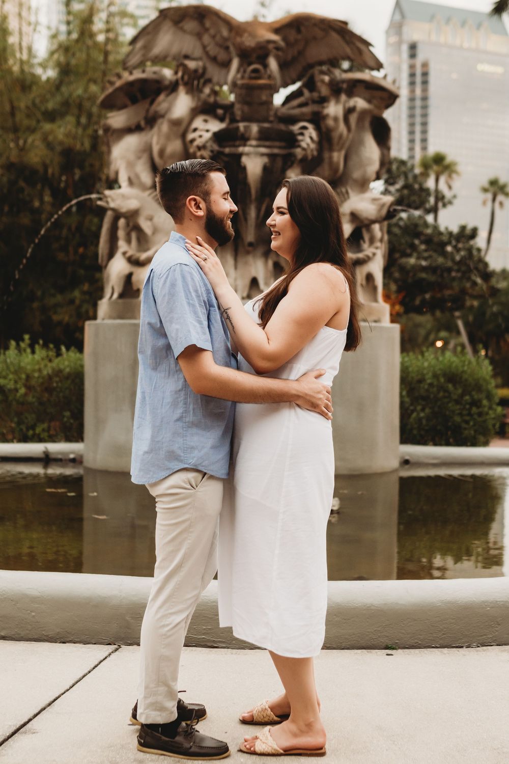 Couple laughing together during a romantic engagement session at The Henry B. Plant Museum in Tampa
