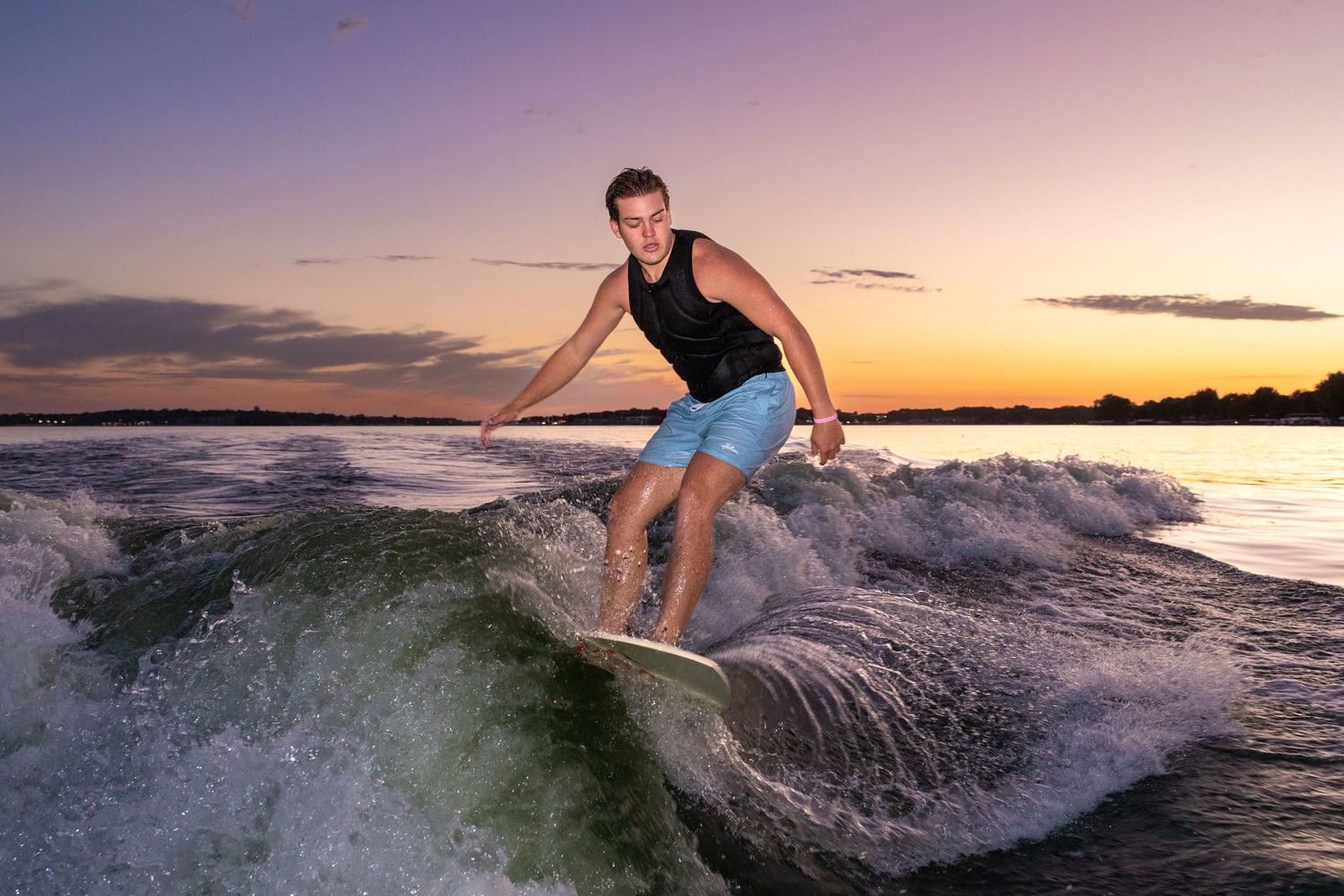 Senior skiing on Lake Okoboji at sunset in late summer.