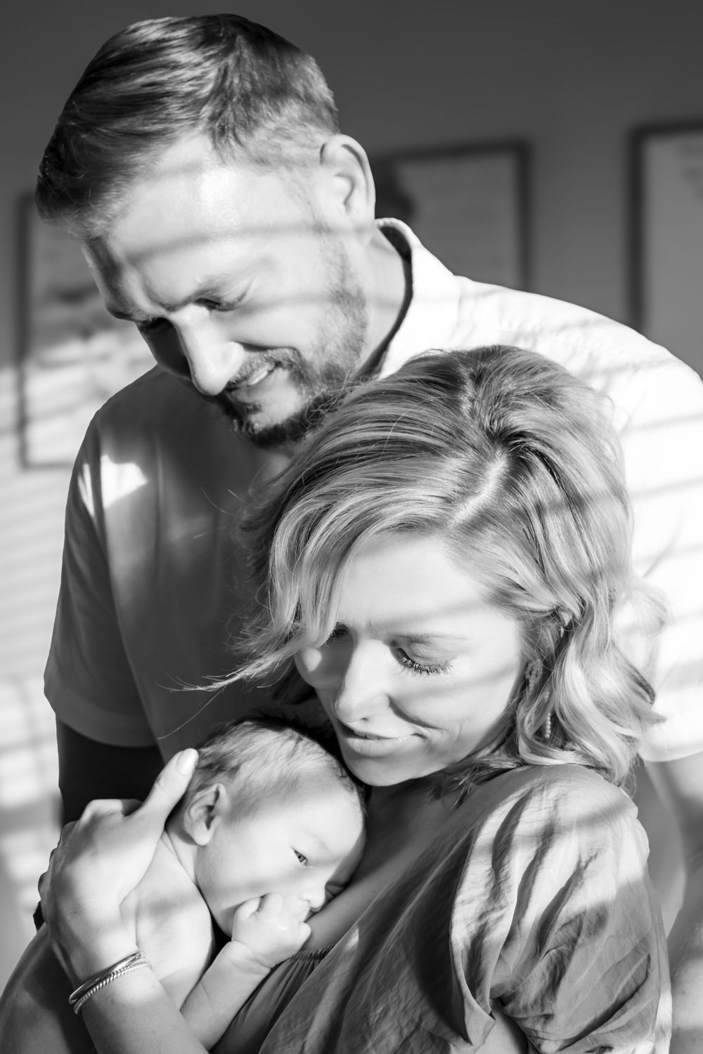 A tender black and white photo sequence showing intimate moments between a couple in close embrace.