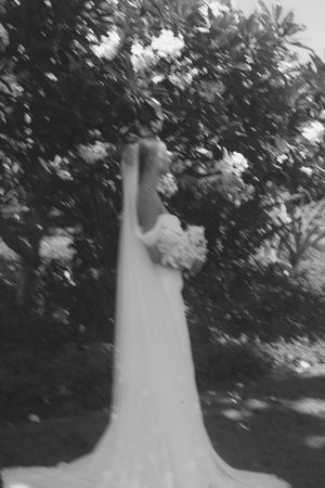 bride posing in front of tree at kauai wedding by Kauai Wedding Photographer