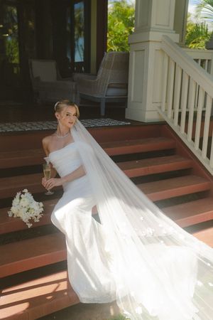 bride posing on stairs at kauai wedding by Kauai Wedding Photographer