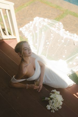 bride posing on stairs at kauai wedding by Kauai Wedding Photographer