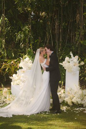 bride and groom kissing during ceremony at Kukuiula Kauai wedding by Kauai Wedding Photographer