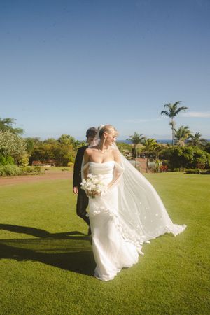 bride and groom walking at Kukuiula Kauai wedding by Kauai Wedding Photographer