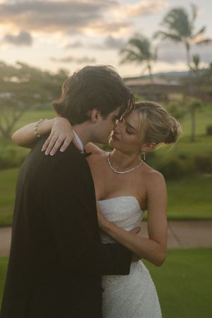 couple posing for sunset photos during golden hour at Kauai wedding by Kauai Wedding Photographer