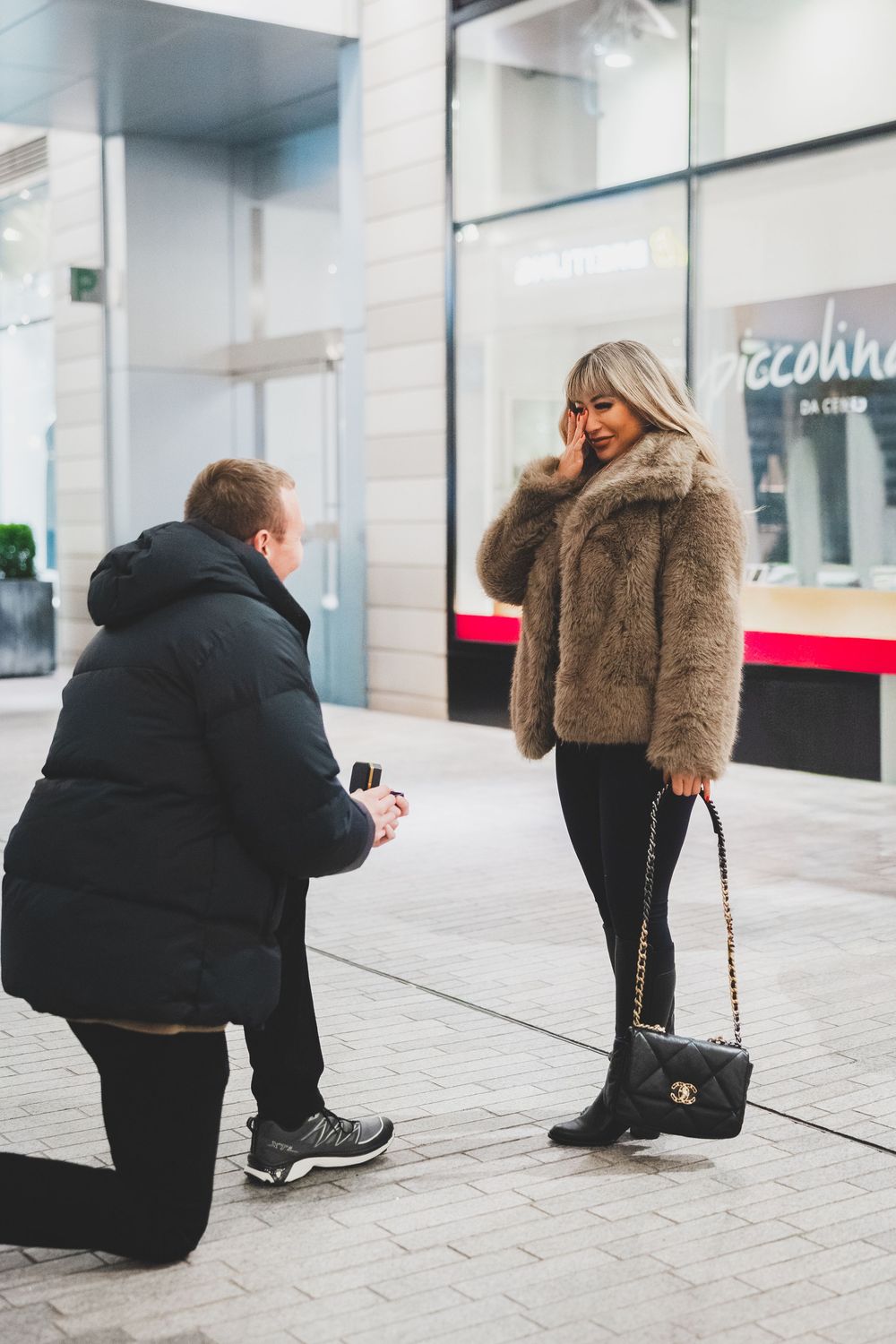 an Intimate moment captured of a man proposing to his girlfriend at the CityCenterDC