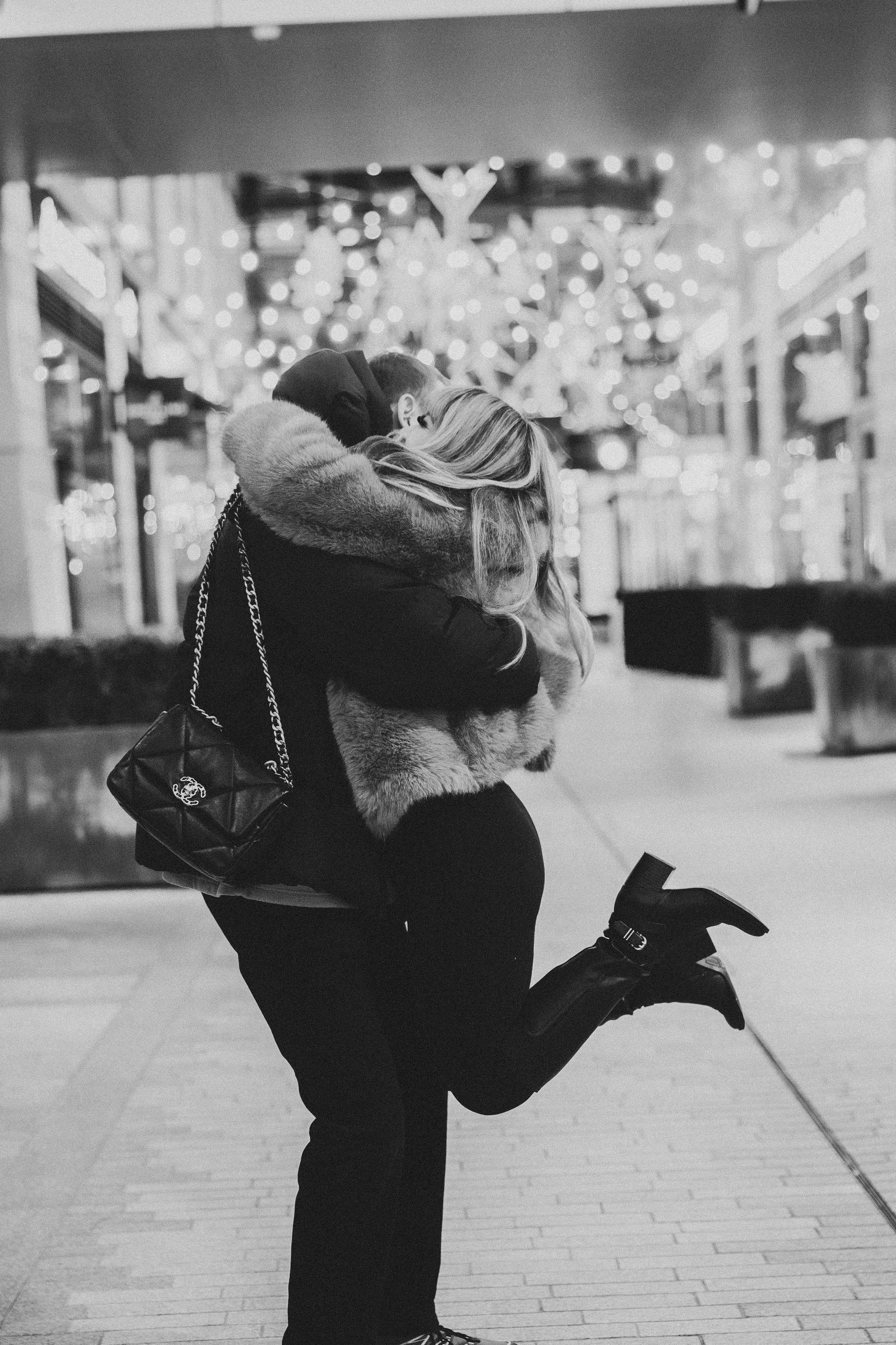 A black and white photo showing the moment she said yes at the CityCenterDC, a prime DC winter proposal location