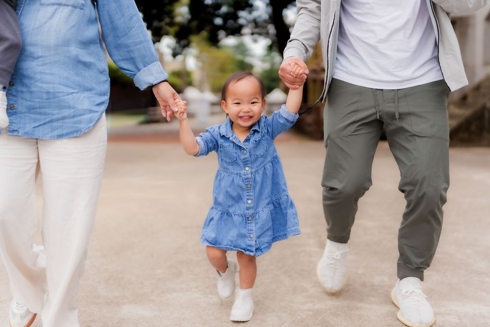 Family members walking together outdoors wearing coordinated blue and white casual outfits.