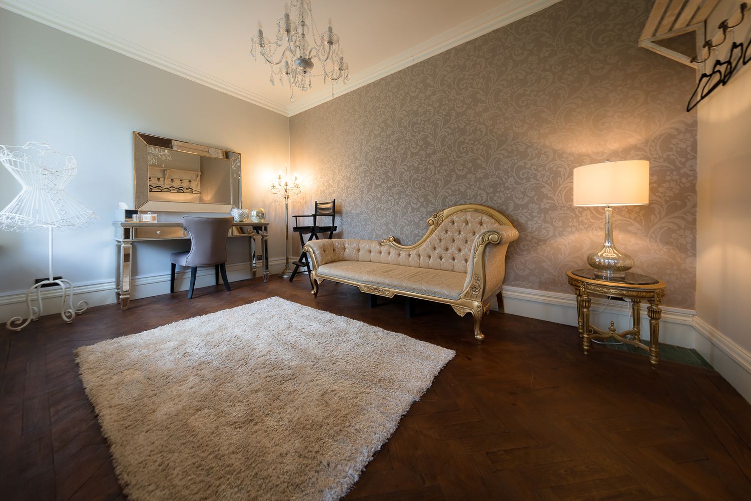 Luxurious reception room with crystal chandelier and plush carpeting in neutral tones. Ellingham Hall