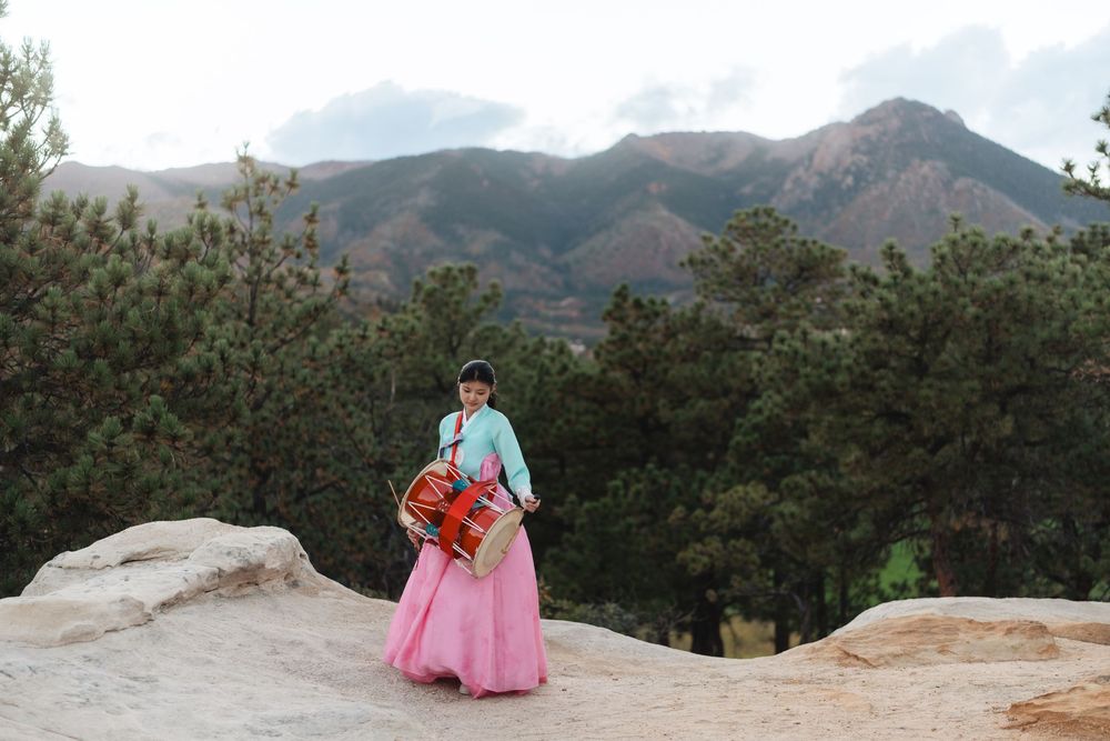A series of scenic mountain landscape photos featuring someone in traditional Korean hanbok dress posing at various viewpoints.