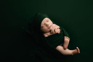 A series of dark artistic photos showing a person in black clothing against a dark background creating dramatic poses.